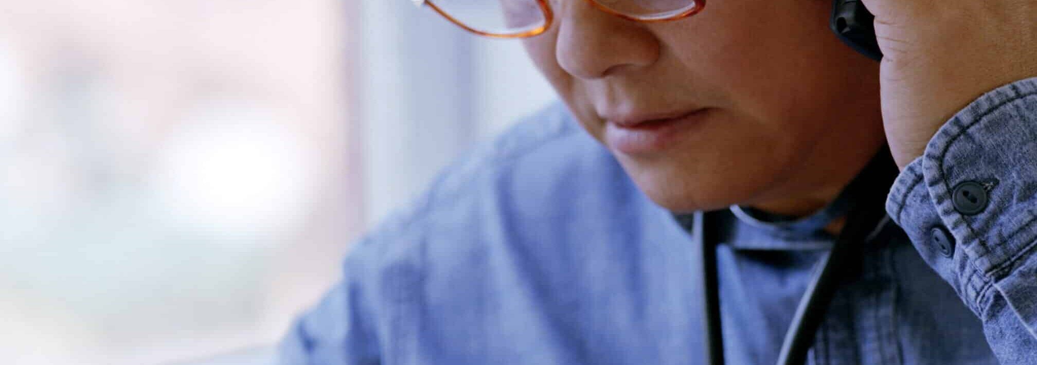 Physician on Phone After Hours with a Medical Device Company Rep While Looking at Material Found Due to Digital Marketing.